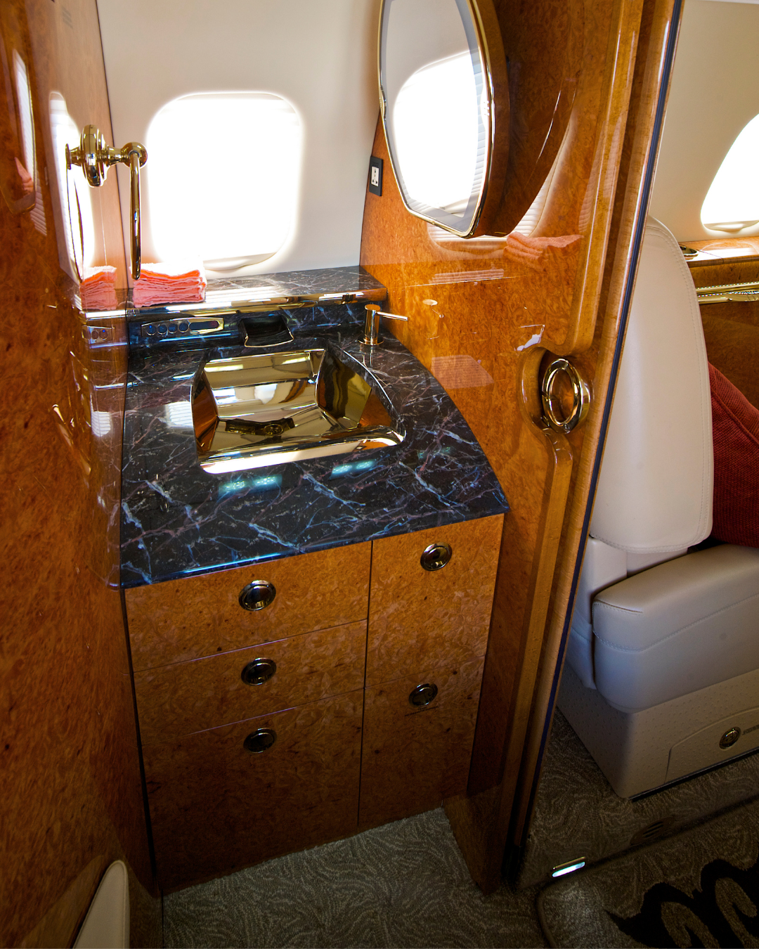 Medium jet interior aircraft detailing - lavatory with marble countertop and wood trim